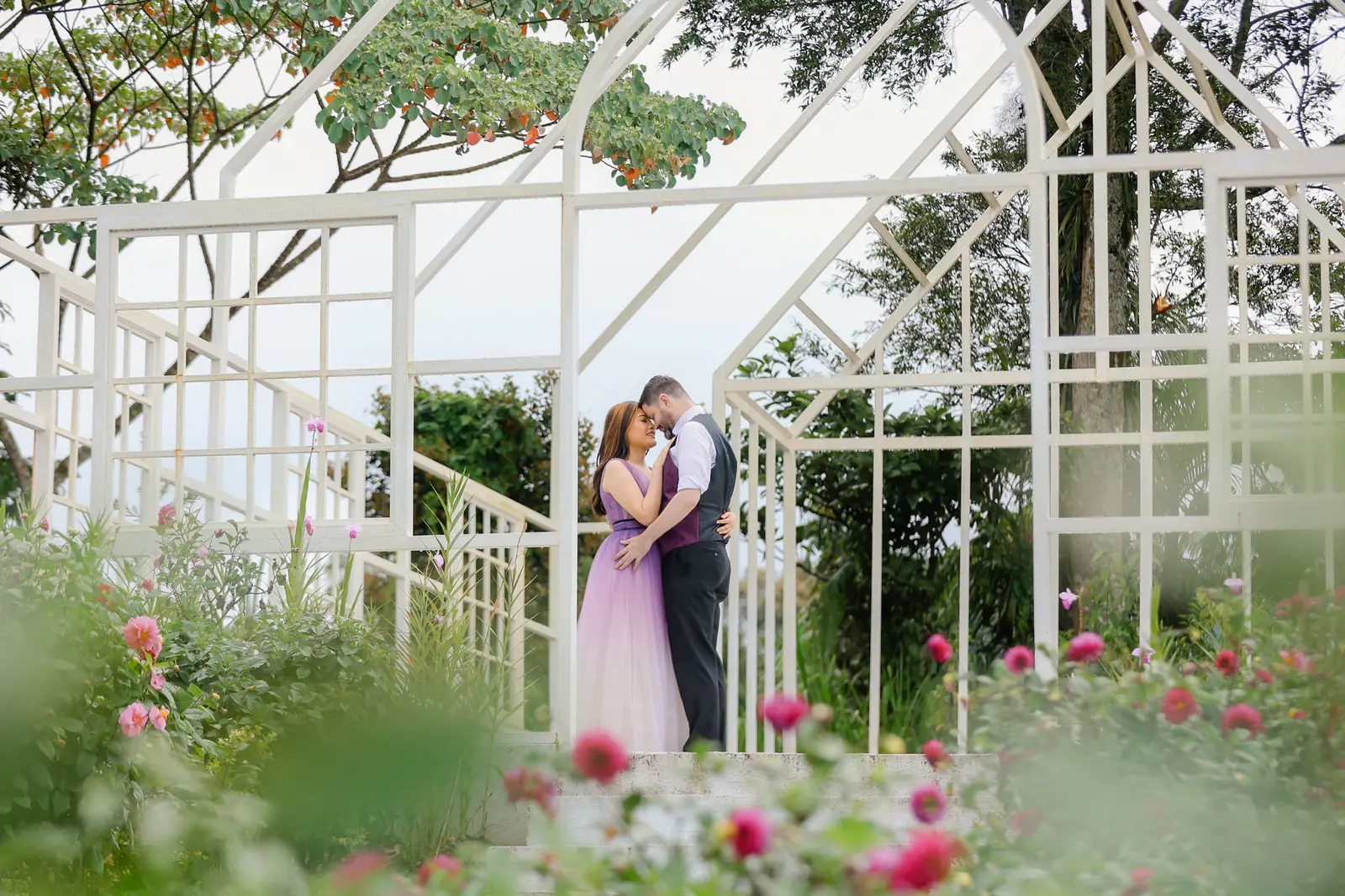 A couple embracing in a garden.