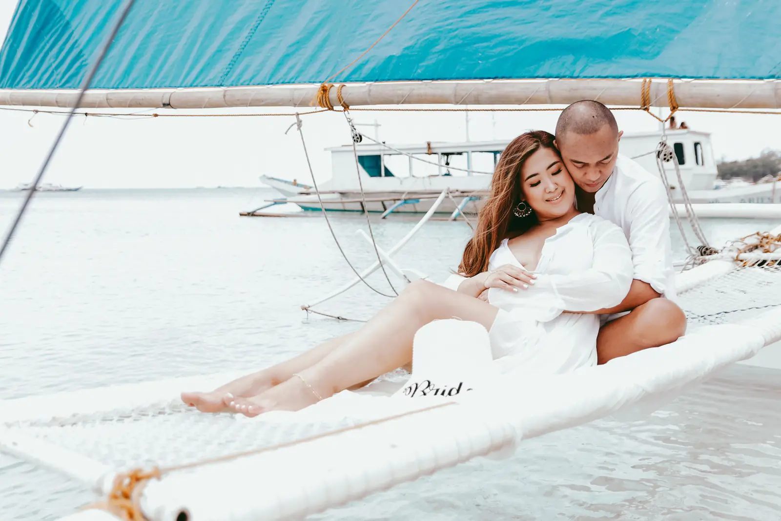 A couple on a sailboat at the seaside in the Philippines.