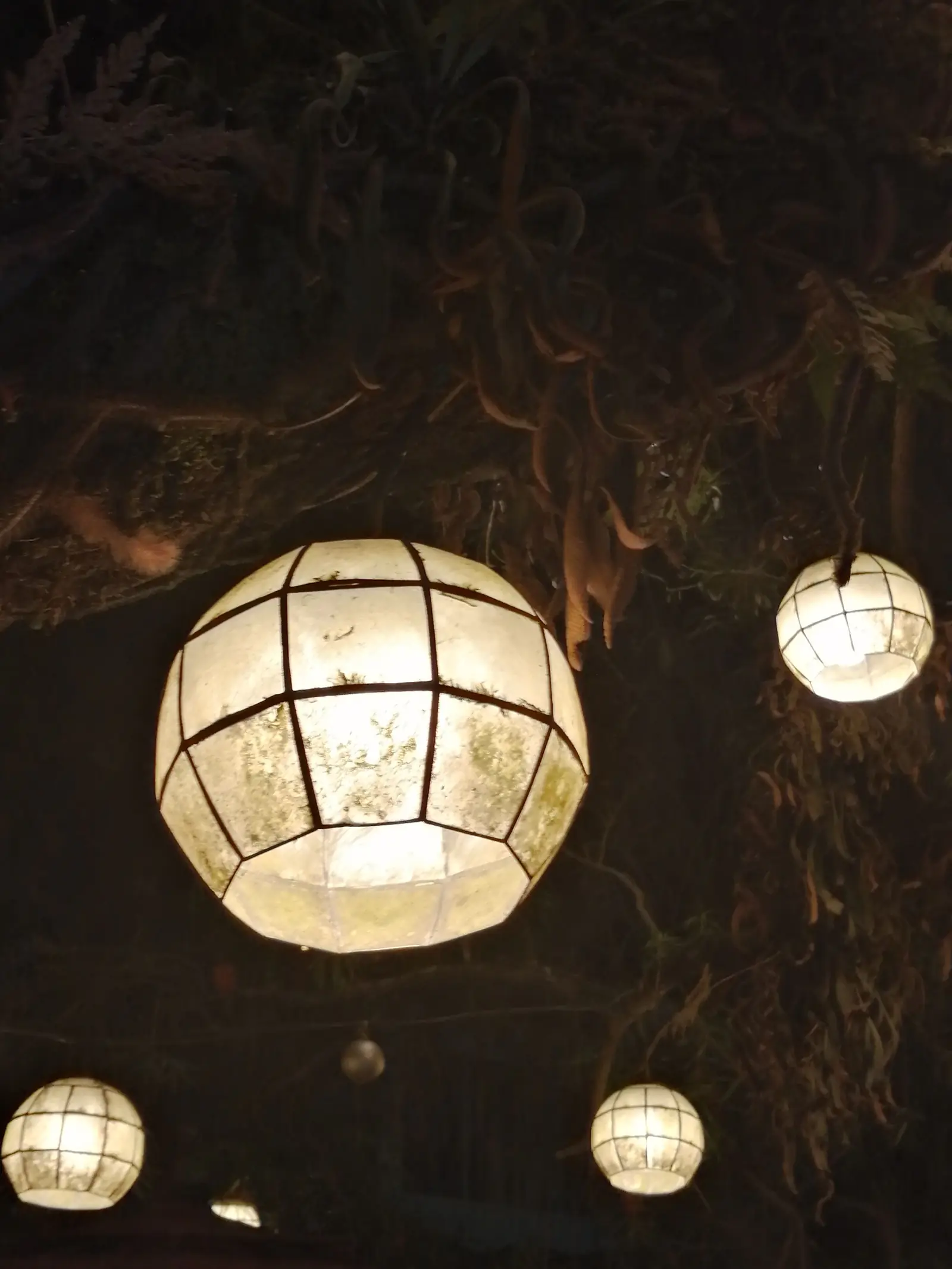 Retro lanterns glowing in a warm, rustic room.