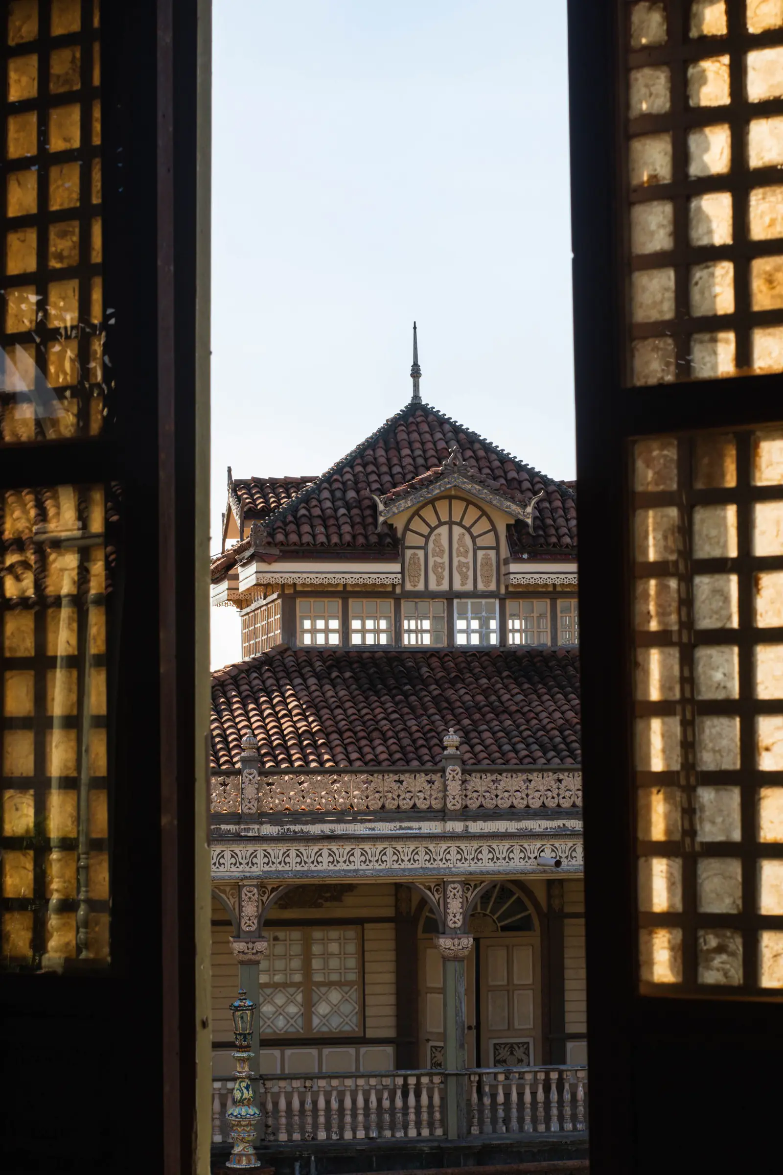 A heritage mansion seen through vintage glass windows.